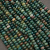 Close-up of green and brown beads on a gray background