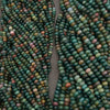 Close-up of two strands of multicolored beads on a gray background