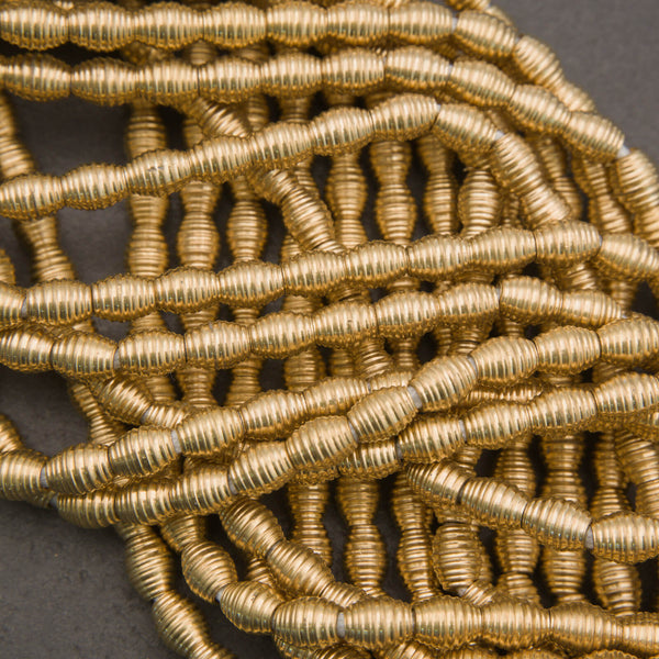 Handcrafted brass beads, organic barrel shapes with grooved surface and soft sheen

