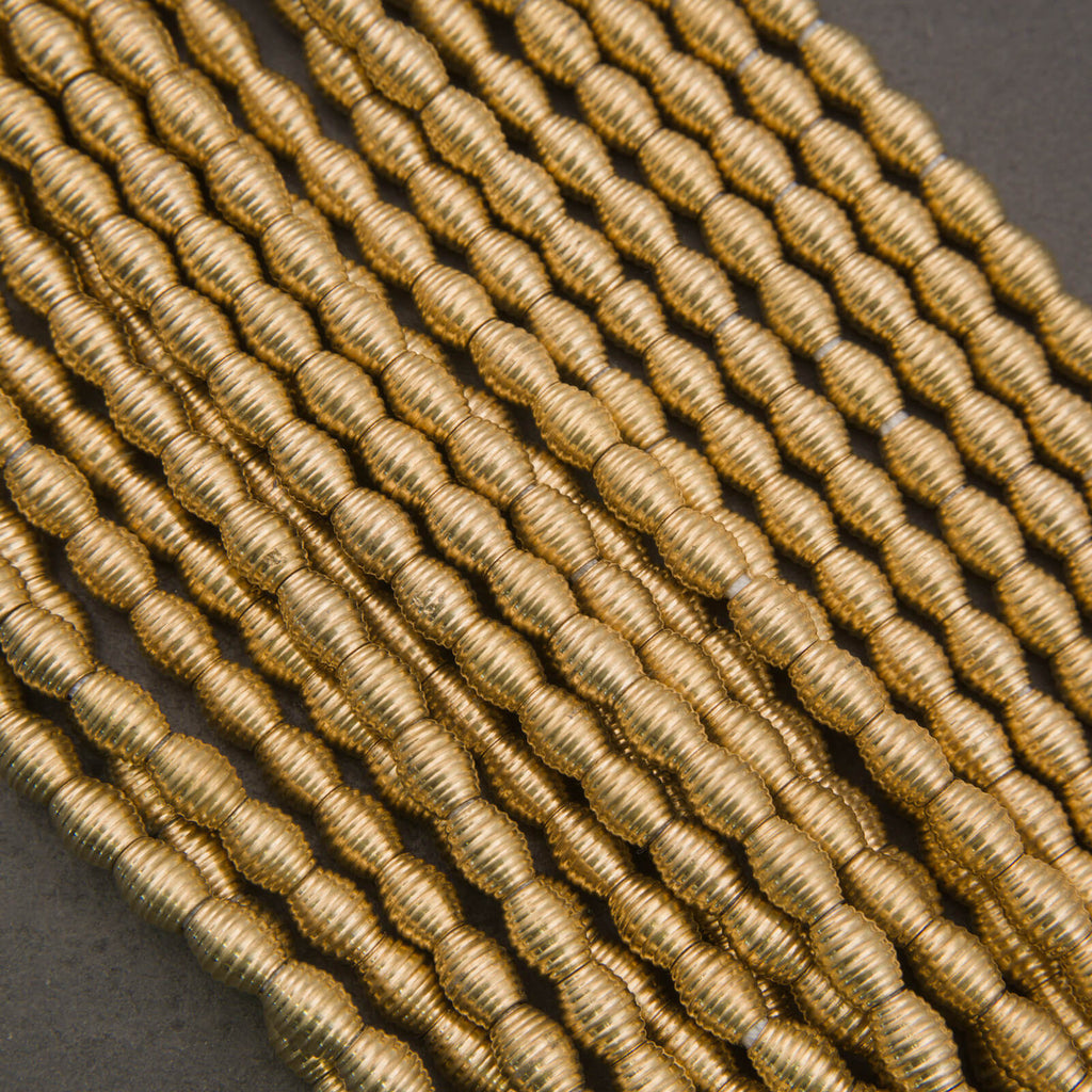 Close-up of gold metallic thread on a dark background