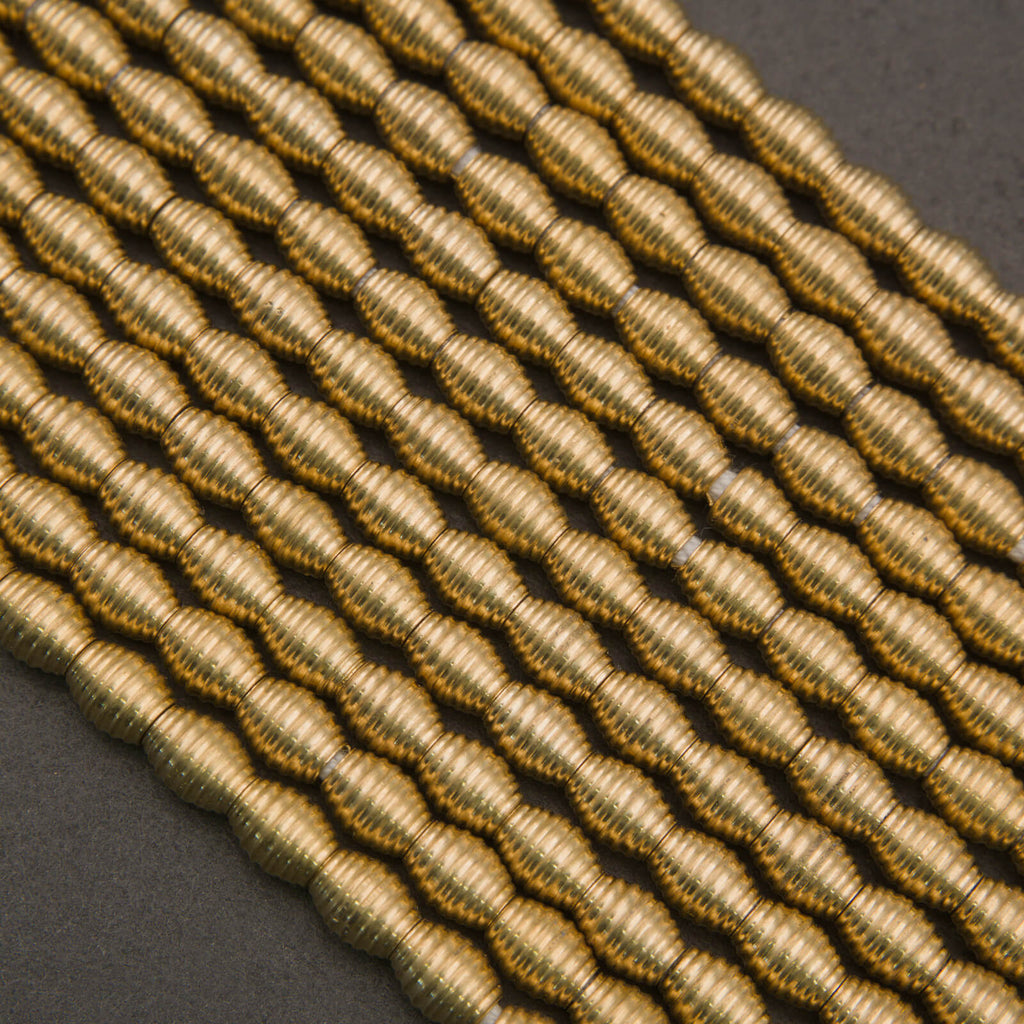 Close-up of braided gold cord on a dark background