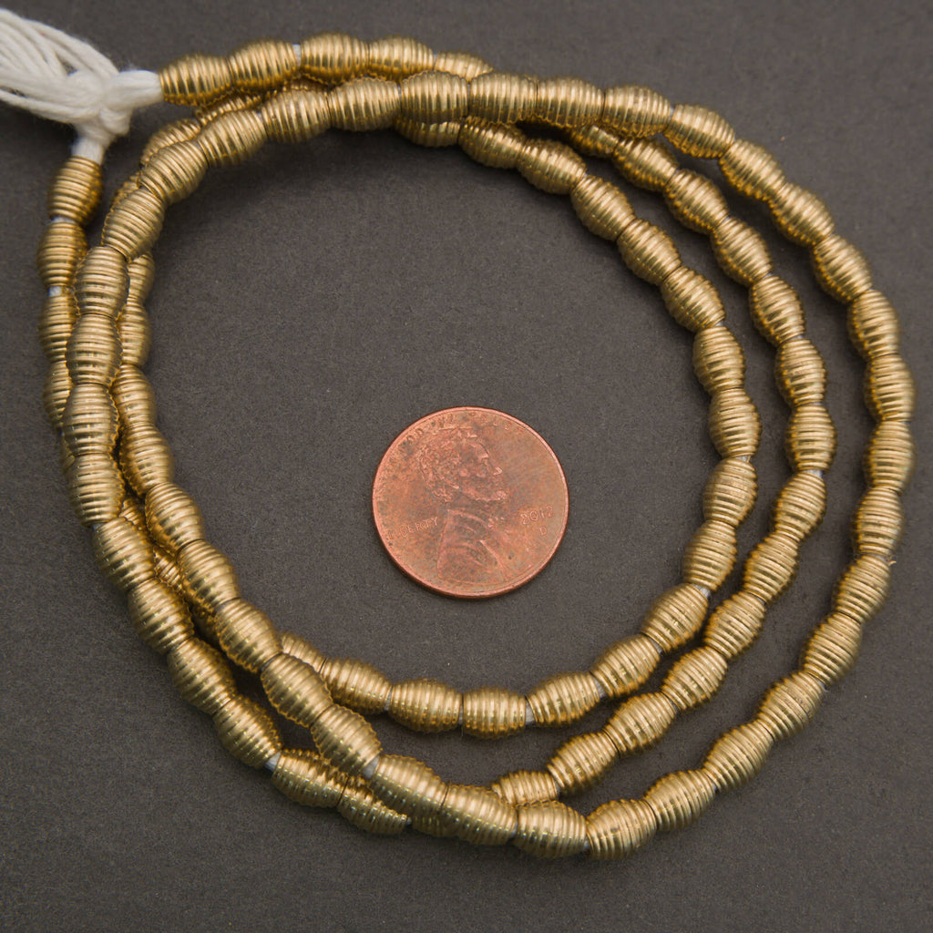 Ribbed brass beads, textured cylindrical spacers in warm metallic gold tones