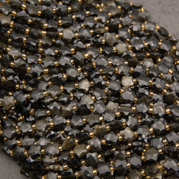 Strands of faceted golden obsidian star beads, some showing a soft golden sheen across the facets