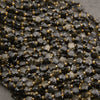 Strands of faceted golden obsidian star beads, some showing a soft golden sheen across the facets