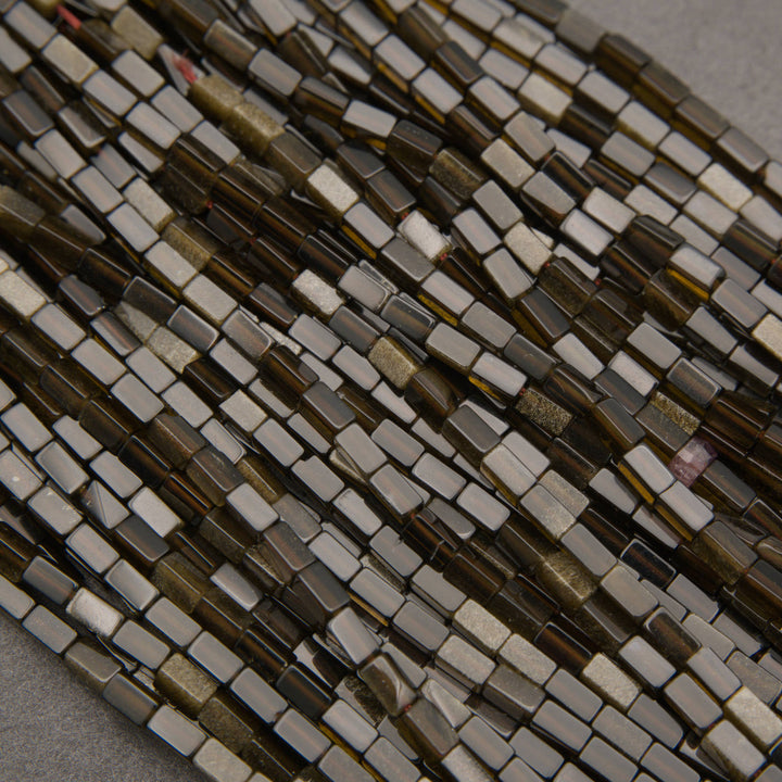 Natural golden obsidian gemstone tube beads with deep smoky brown tones and shimmering golden highlights.