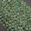 Natural green aventurine gemstone beads featuring four-petal floral shapes and a frosted finish.