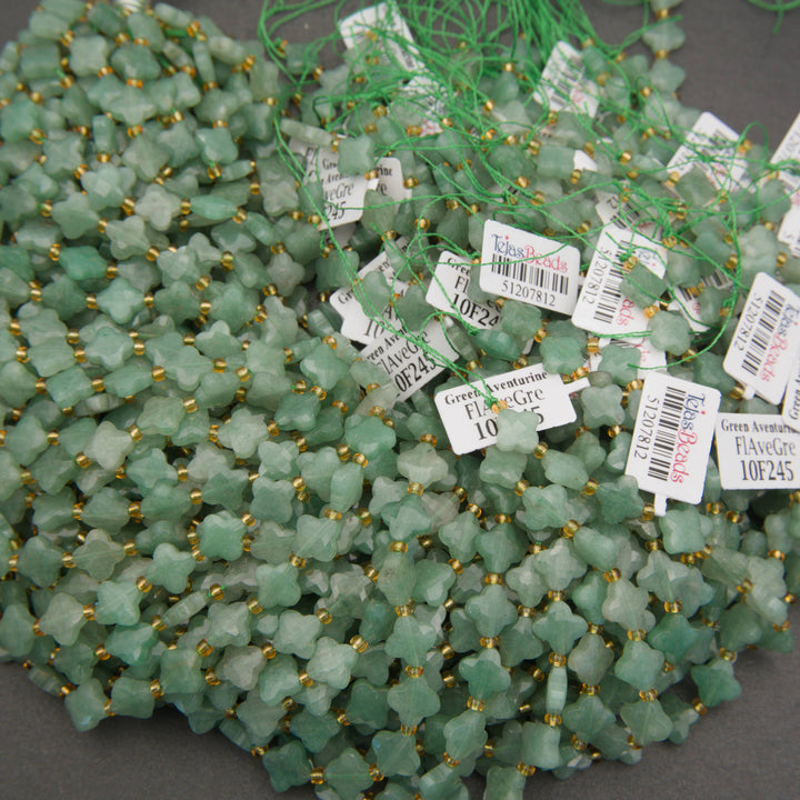 Strands of faceted green aventurine clover beads with a soft, translucent appearance.