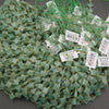 Strands of faceted green aventurine clover beads with a soft, translucent appearance.