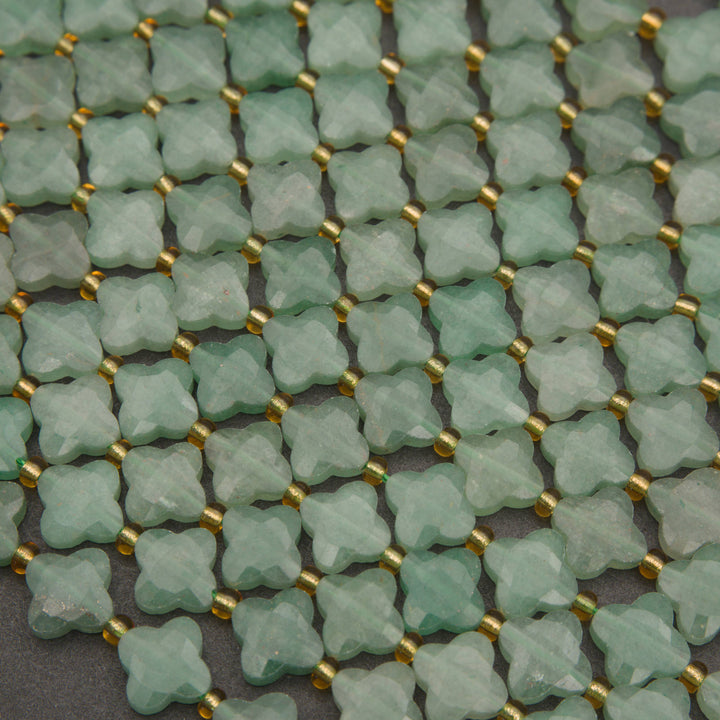 Strands of faceted green aventurine clover beads with a soft, translucent appearance.