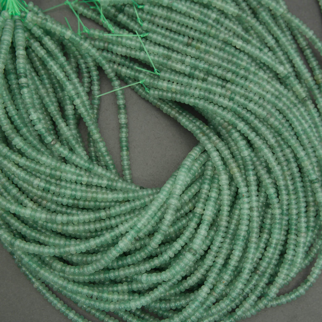 Translucent green aventurine beads rondelle cut gemstone strand close up