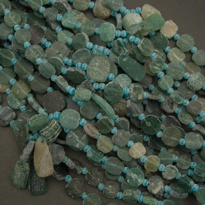 Green and blue beaded necklace on a dark surface