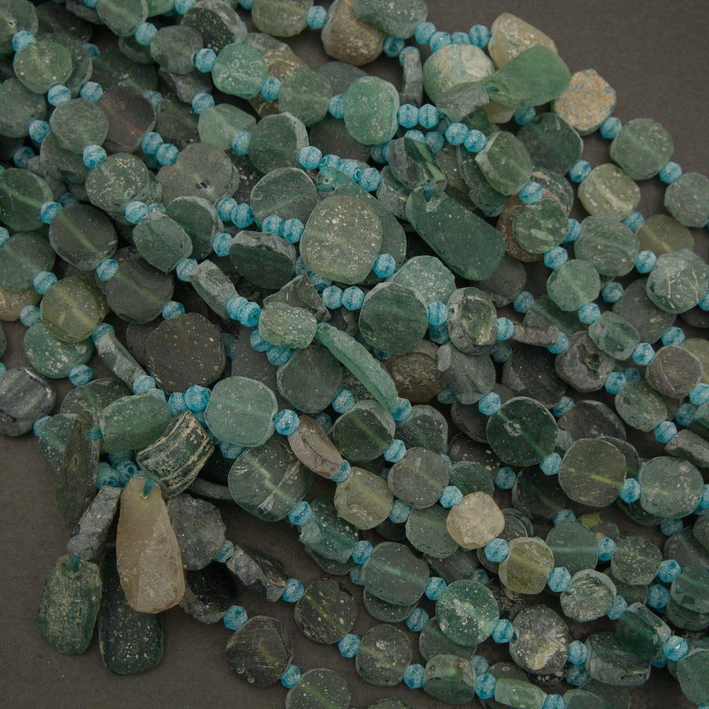 Green and blue beaded necklace on a dark surface
