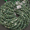 String of green beads with price tags on a dark surface