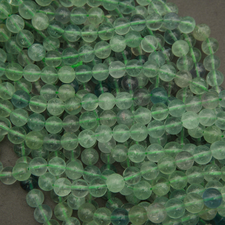 Close-up of green glass beads on a dark background