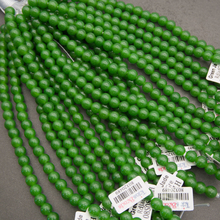 Half strands of smooth round green jade large hole beads with Tejas Beads tags