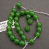 A half strand of green jade large hole beads with its tag, showing the wide bead holes