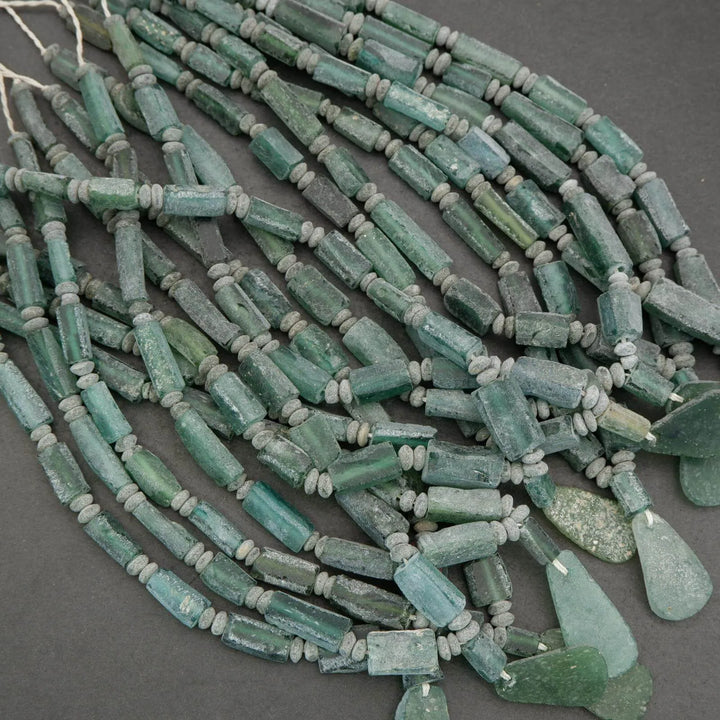 String of green beads on a gray background