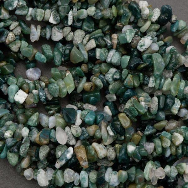 Close-up of green and white pebbles on a gray background