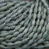 Close-up of green beads with silver accents on a string