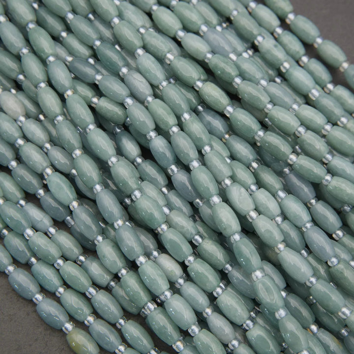 Close-up of green beads with silver spacers on a dark background