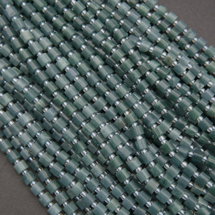 Close-up of a green woven mat with a grid pattern on a gray background