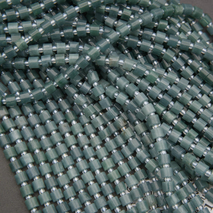 Close-up of green beaded string on a gray background