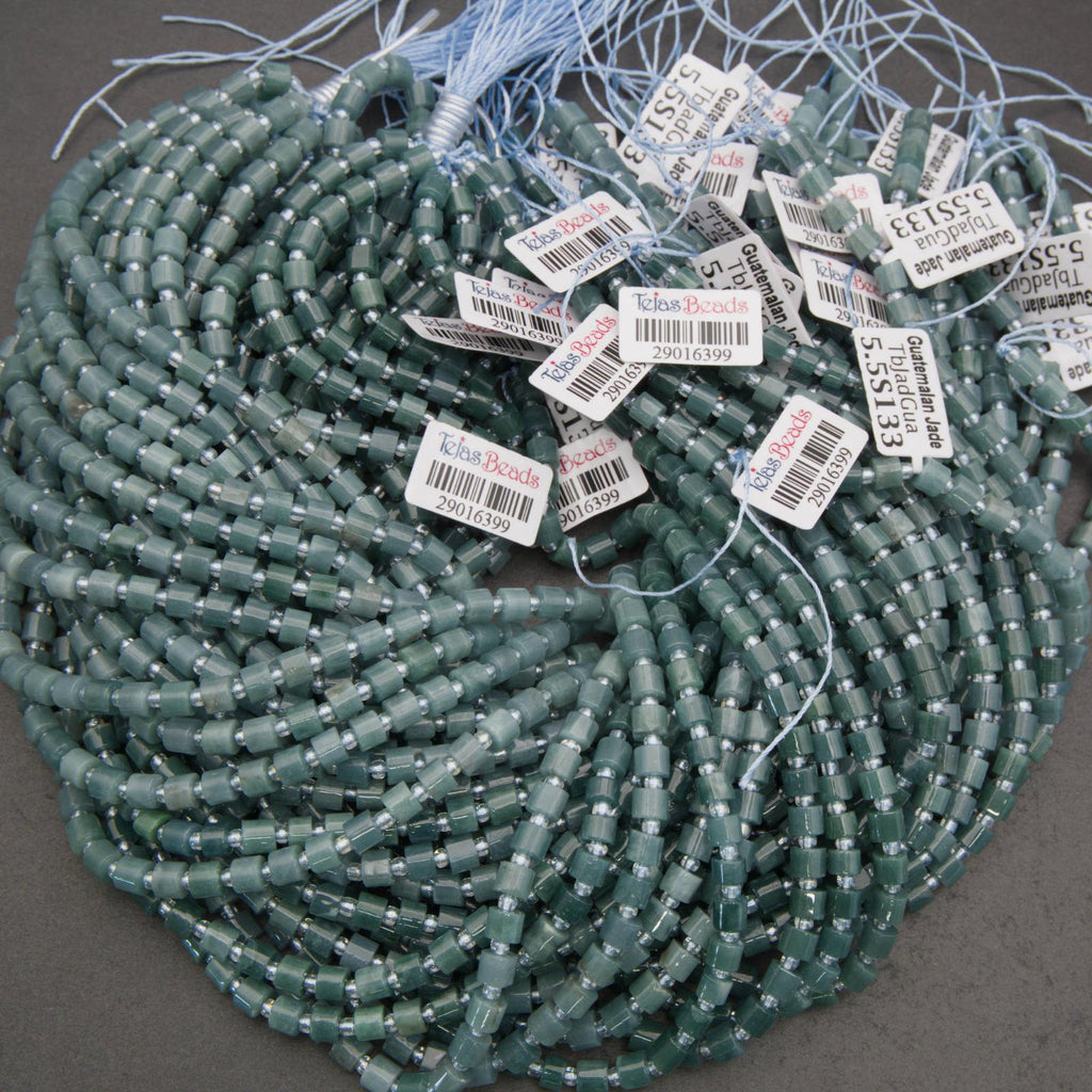 Green beads with labels on a gray surface