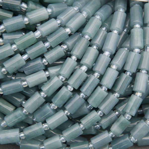 Stack of green plastic caps with metal inserts on a dark background