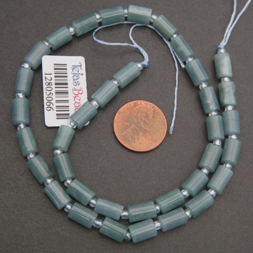 Beaded necklace with a penny for scale on a gray background