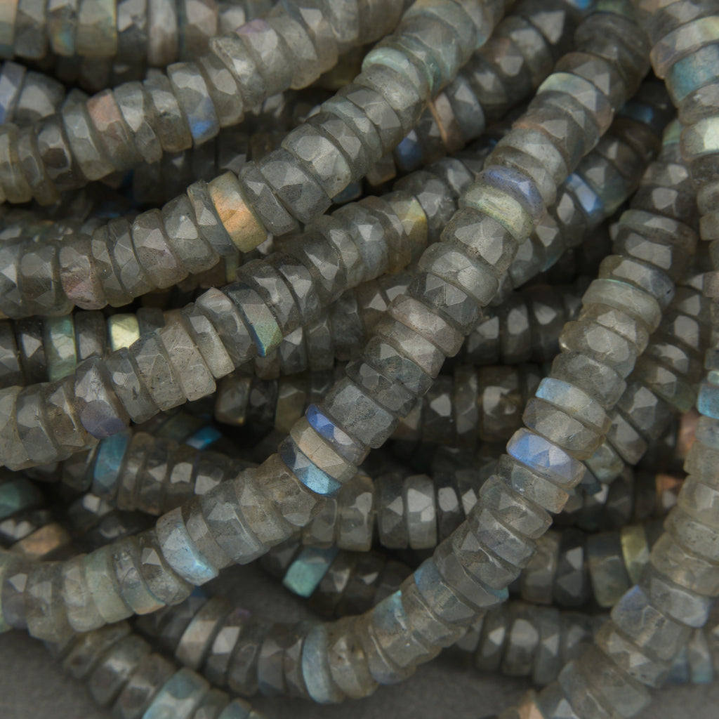Close-up of a string of dark gray beads with blue highlights