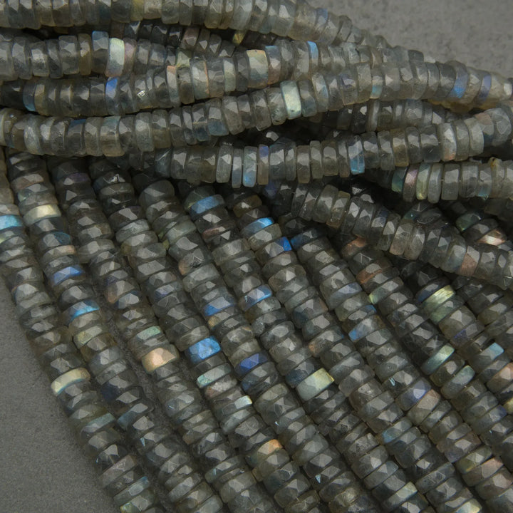 Close-up of dark blue faceted beads on a gray background