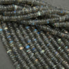 Close-up of dark blue faceted beads on a gray background