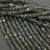 Close-up of dark blue faceted beads on a gray background
