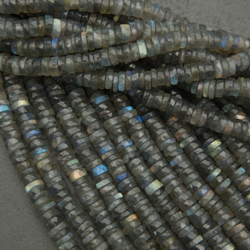 Close-up of dark blue faceted beads on a gray background