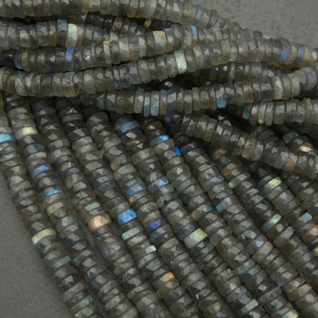 Close-up of dark blue faceted beads on a gray background
