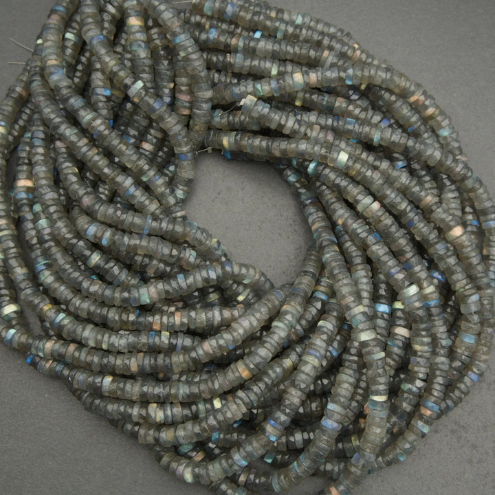 Coiled string of dark blue beads on a gray background