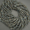 Coiled string of dark blue beads on a gray background