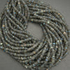 Coiled string of dark blue beads on a gray background