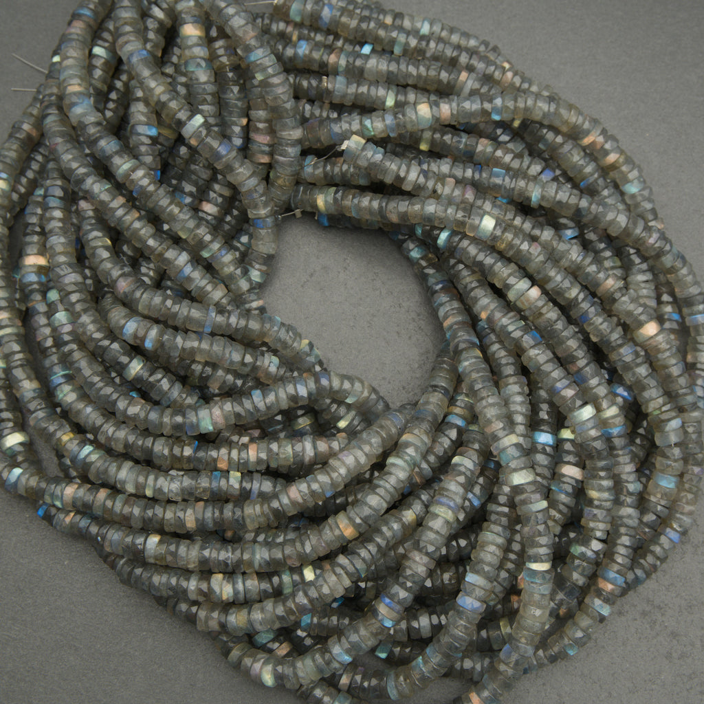 Coiled string of dark blue beads on a gray background