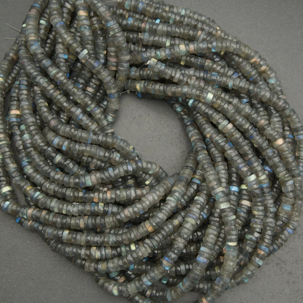 Coiled string of dark blue beads on a gray background