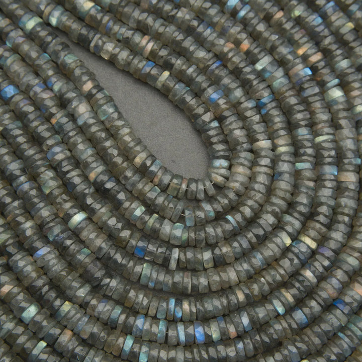 Close-up of a string of dark green beads with a gray background