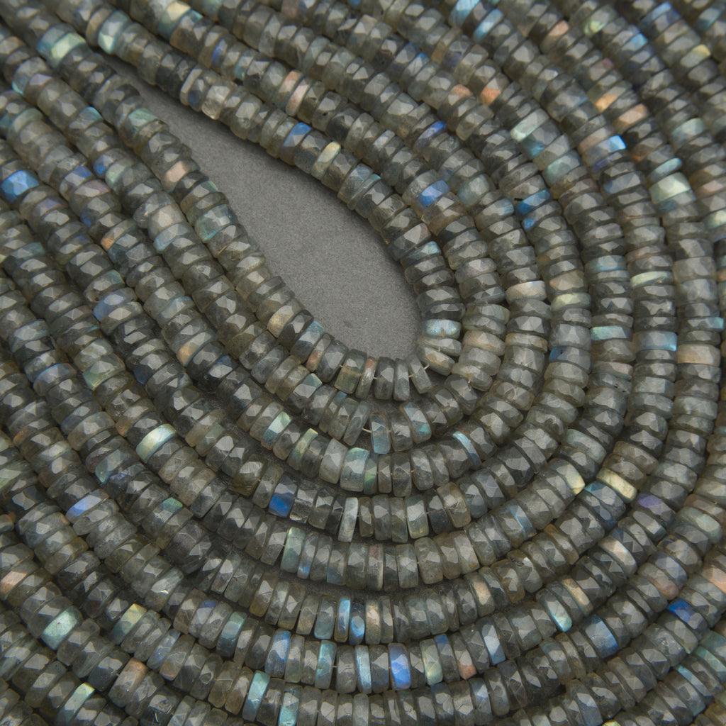 Close-up of a string of dark green beads with a gray background