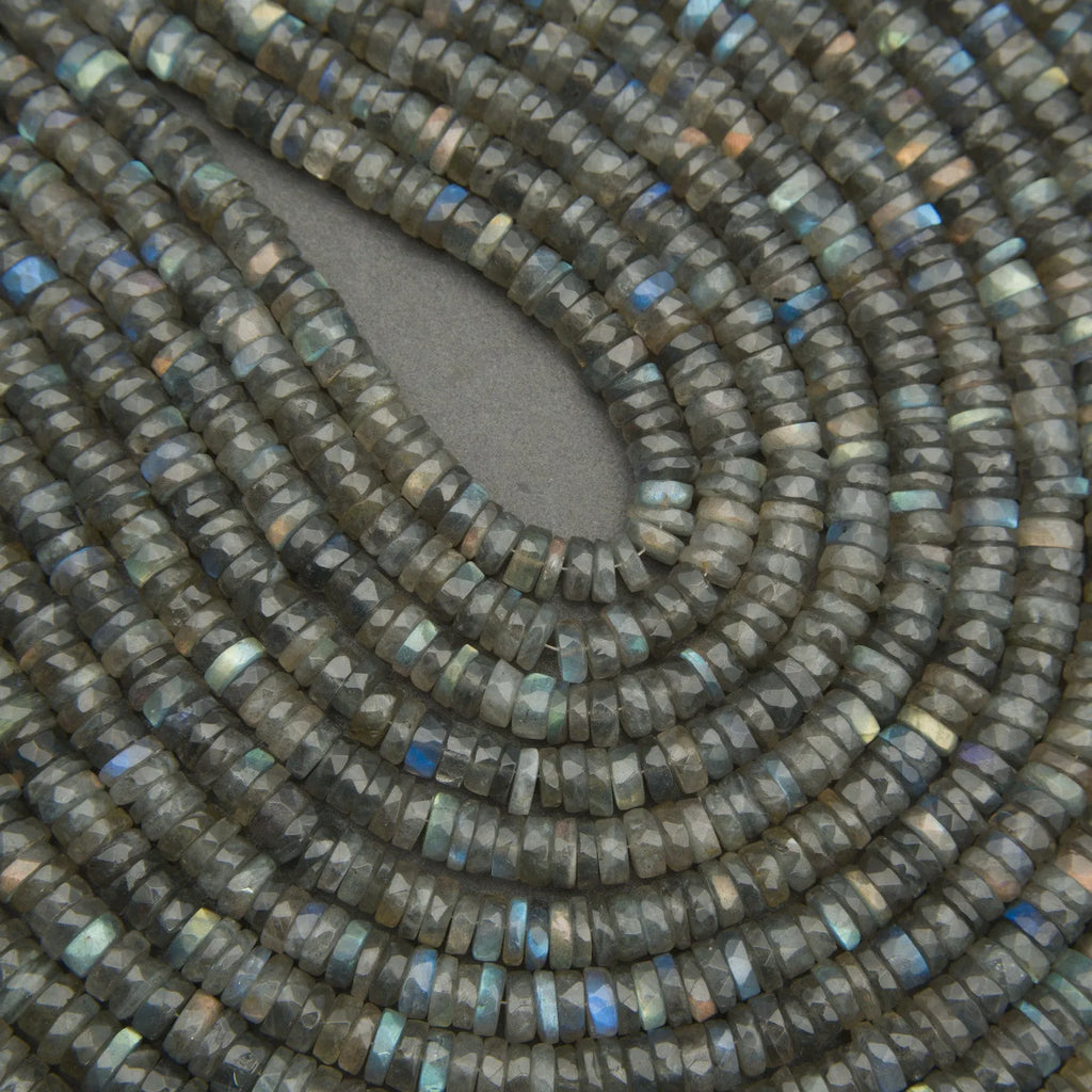 Close-up of a string of dark green beads with a gray background