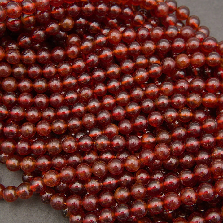 Glossy Hessonite Garnet gemstone beads featuring warm amber and deep red tones