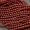Glossy Hessonite Garnet gemstone beads featuring warm amber and deep red tones