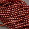 Glossy Hessonite Garnet gemstone beads featuring warm amber and deep red tones