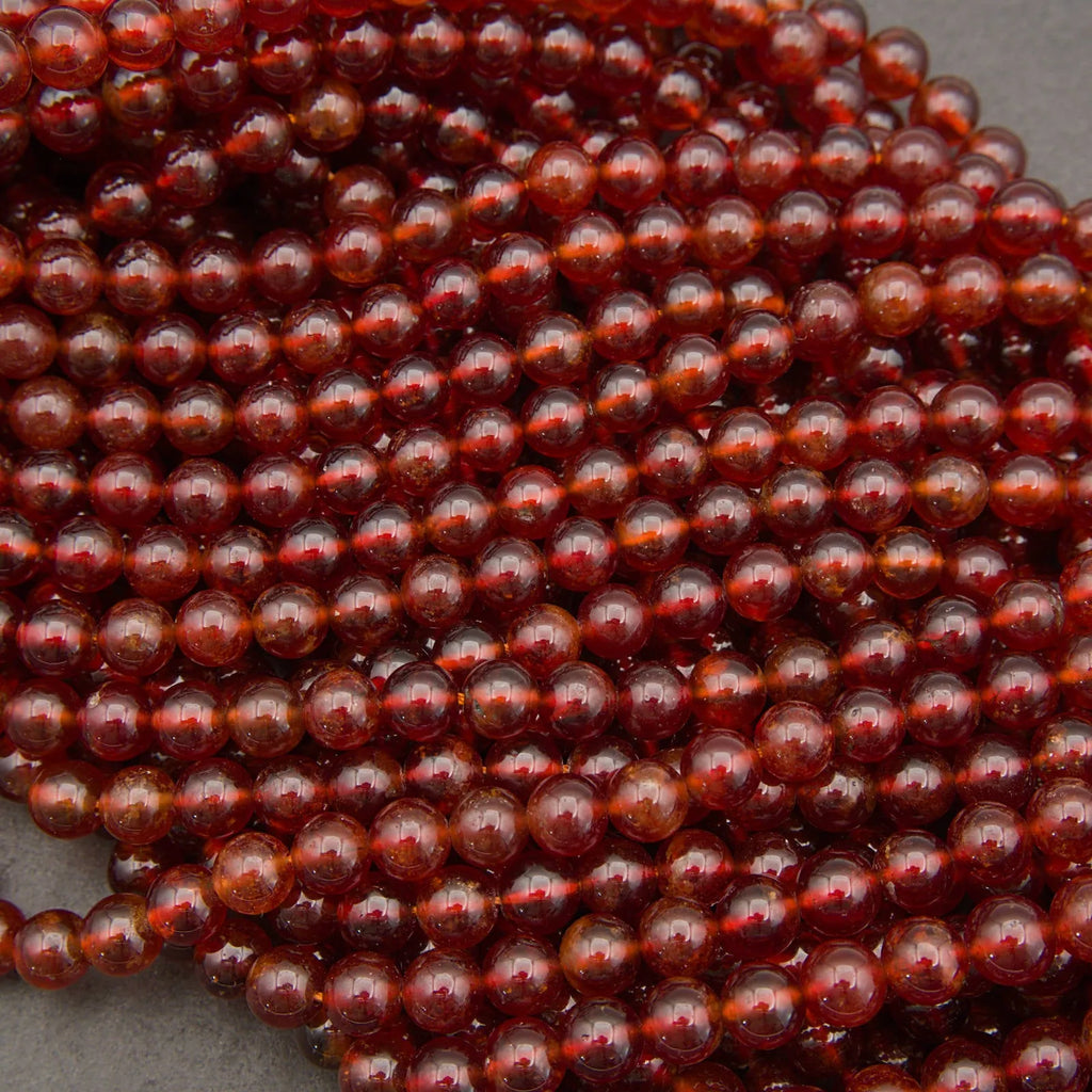 Glossy Hessonite Garnet gemstone beads featuring warm amber and deep red tones