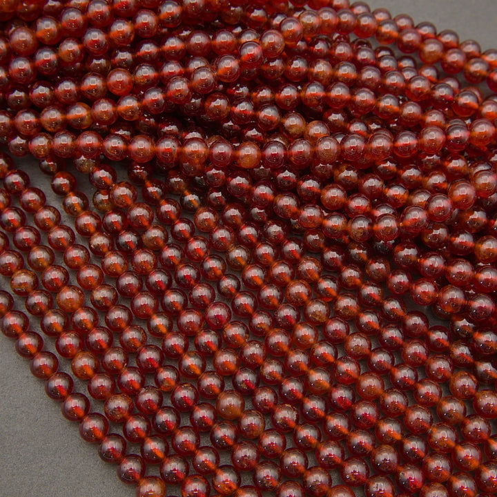 Glossy Hessonite Garnet gemstone beads featuring warm amber and deep red tones