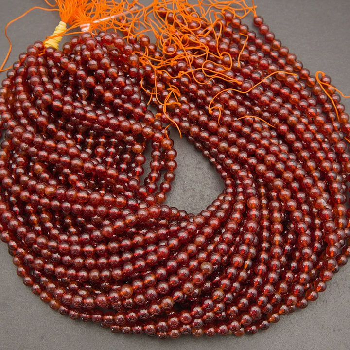 Glossy Hessonite Garnet gemstone beads featuring warm amber and deep red tones
