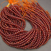 Glossy Hessonite Garnet gemstone beads featuring warm amber and deep red tones